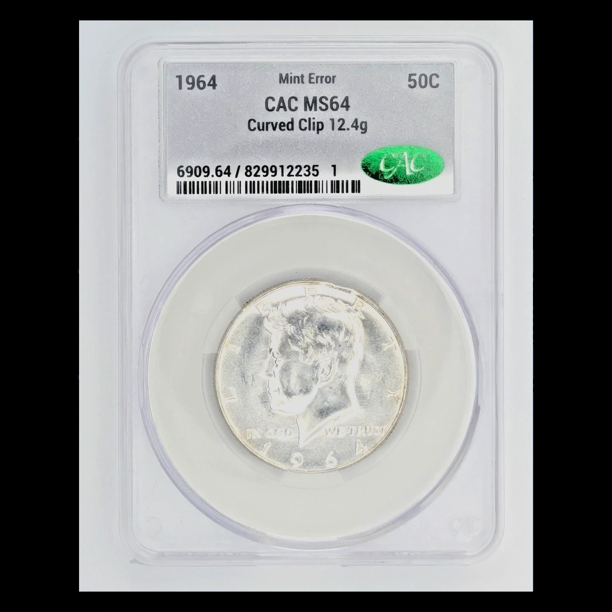 1964 Kennedy half dollar with a curved clip at the edge