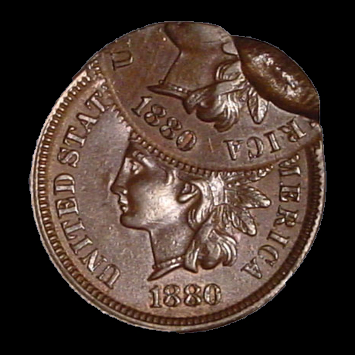 1880 Indian Head cent double struck with the second strike 55 percent off center and an indent